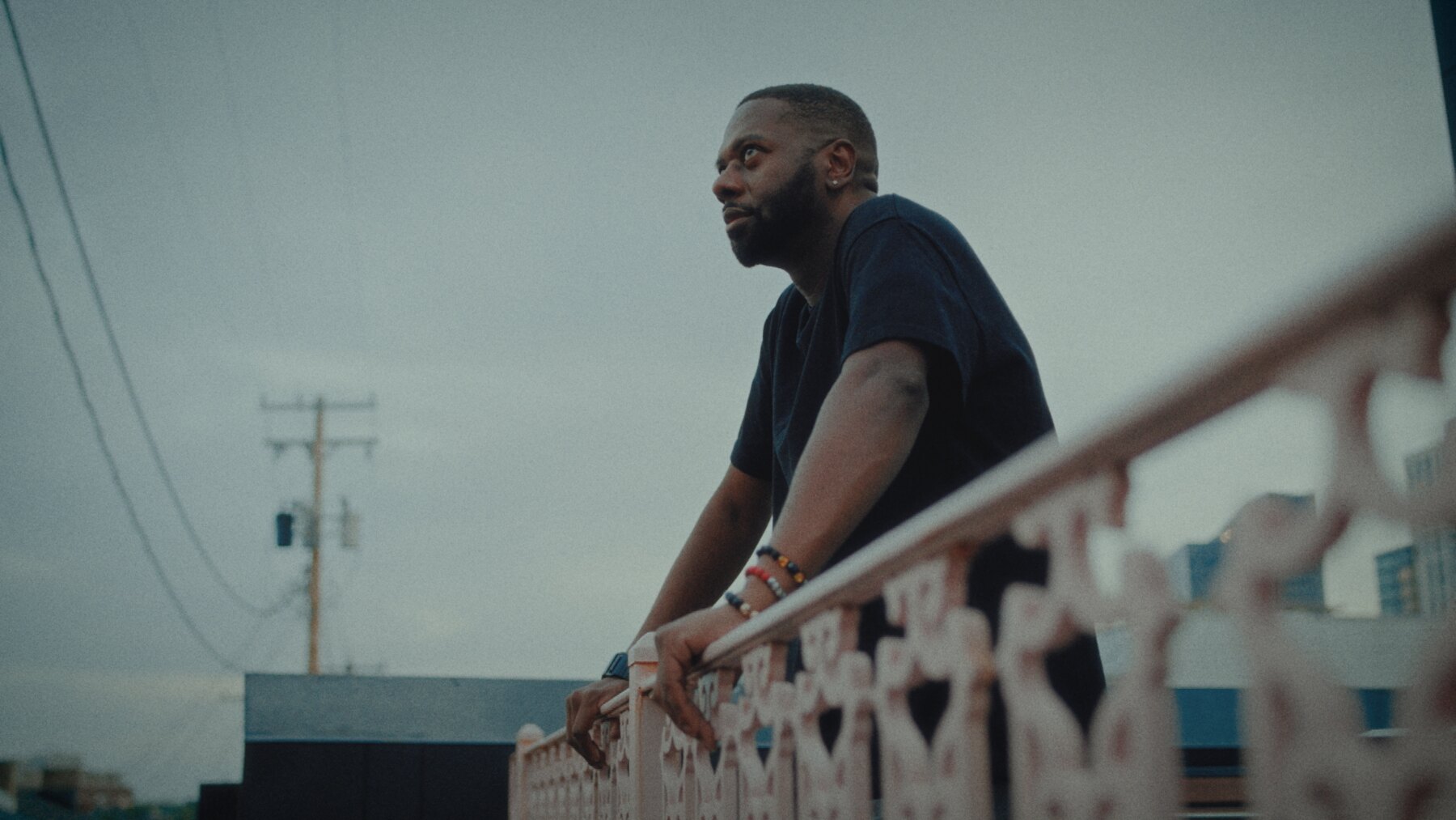 Mark Anthony Thomas standing on a balcony in In Need of Seawater.